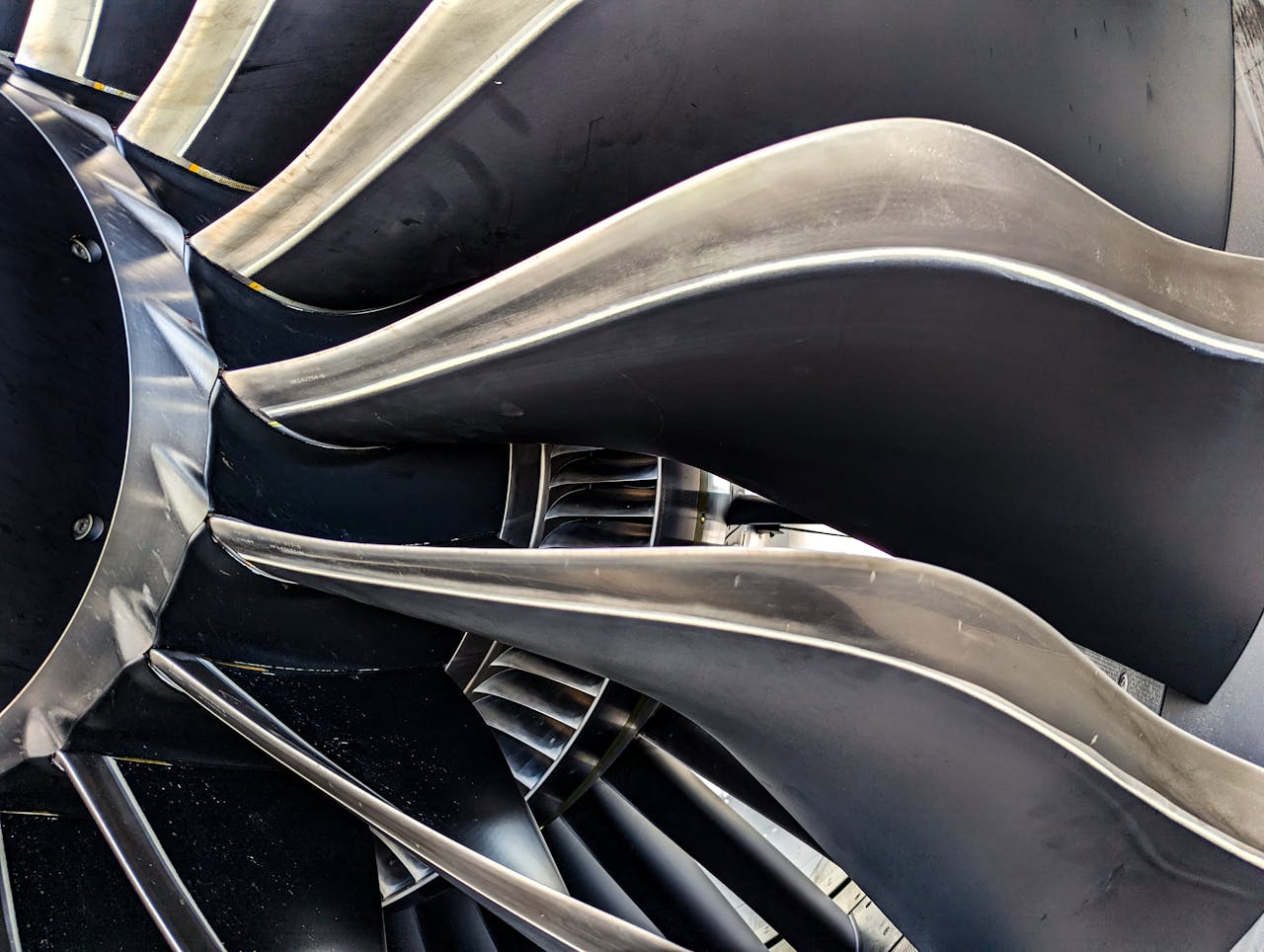 Detailed close-up of metal turbine blades showcasing engineering and aerodynamic design.